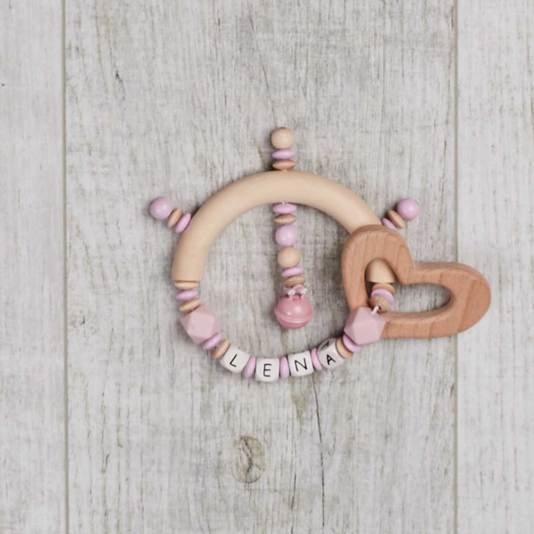 Gripper made of silicone and wood with little bell and heart, pink